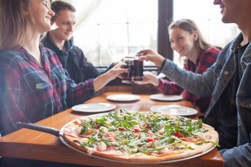 friends of classmates eat pizza in a pizzeria, students at lunch eat fast food