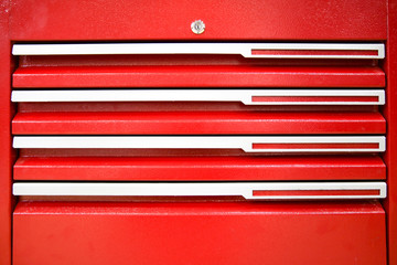 background of joiner's metal box. metal drawer drawers. texture of red toolbox