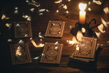 Tarot cards on the table and mystic light around concept.