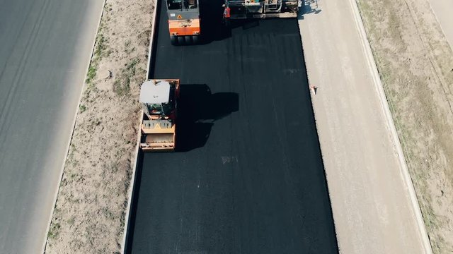 Top view of an asphalt road getting done by the workers