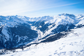 Photo of picturesque highlands with snow mountains and blue sky