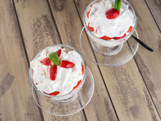 Glass bowl of strawberries with whipped cream - 302063679