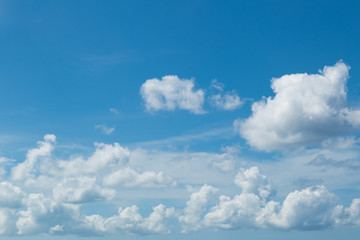 Naklejka na ściany i meble Beautiful natural sky background: white cumulus clouds on blue sky