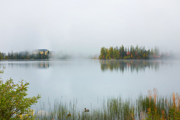 The misty autumn Strsbke lakewith reflection on water in high Tatra mountains in Slovakia