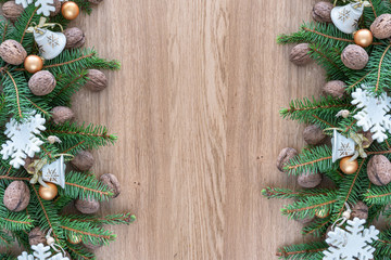 Christmas composition. Green branches of a Christmas tree on wood background.