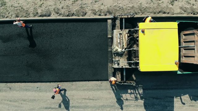 Asphalt road is being made by the workers