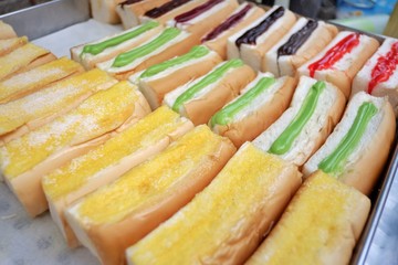 A tray of steamed breads with Thai custard and jam ,selling at street food market area in China town (known as Yaowaraj) ,Bangkok,Thailand