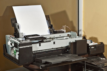 The printer is disassembled into parts. Broken, dirty and dusty printer. Service center for...