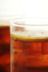 Glasses with cuba libre cocktail or cola with ice or cold tea with lemon	