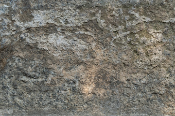 Texture of natural gray weathered stone. Background of stone covering a wall or floor texture surface with lines. Old stone with.