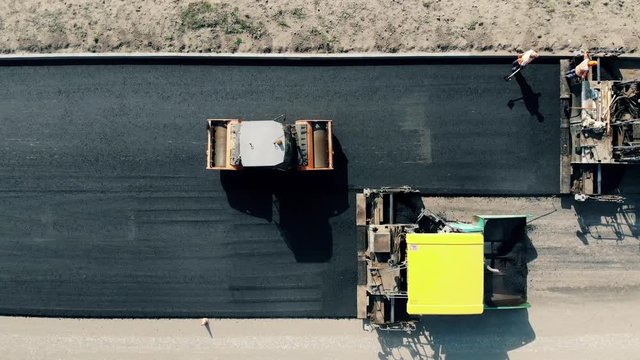 Top view of industrial machinery laying asphalt