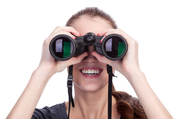 Young smiling woman looking through binoculars isolated on white background