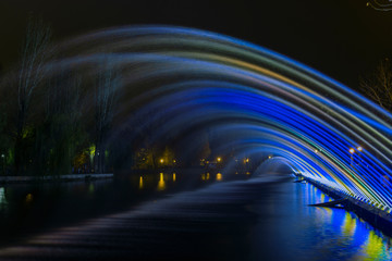 long exposure night city illumination from highlighted fuzzy fountain stream  