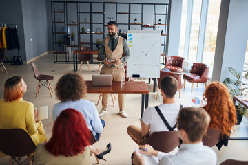 Coach trainer in formal wear give presentation to young co-workers, share with experience