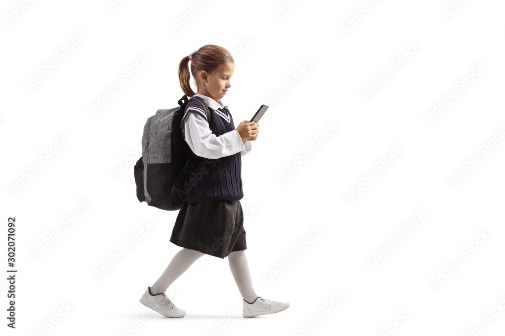 Sticker Little schoolgirl walking and typing on a smartphone