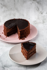 Delicious chocolate cake on plate on table on marble background. Wallpaper for pastry cafe or cafe menu. vertical.