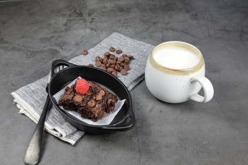 Homemade Chewvy Brownie with Raspberries and a cup of milk