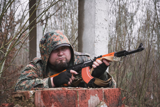 Russian soldier with kalashnikov in the forest