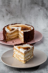 Delicious victoria sponge cake with white cream on plate on table on marble background. Wallpaper for pastry cafe or cafe menu. vertical.