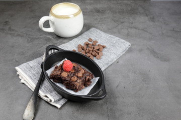 Homemade Chewvy Brownie with Raspberries and a cup of milk