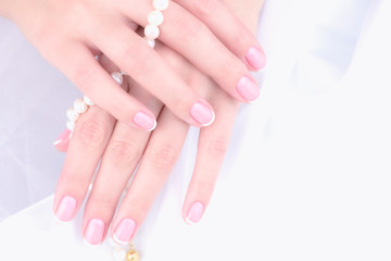 Wedding manicure. Female hand with french manicure on a white background.
