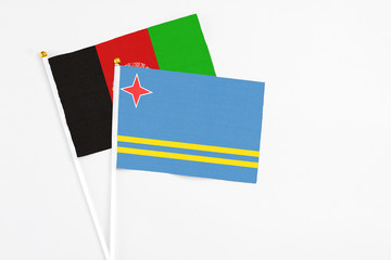 Aruba and Afghanistan stick flags on white background. High quality fabric, miniature national...