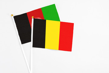 Belgium and Afghanistan stick flags on white background. High quality fabric, miniature national...