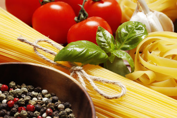 Composition with pasta cooking ingredients on wooden table, space for text and closeup