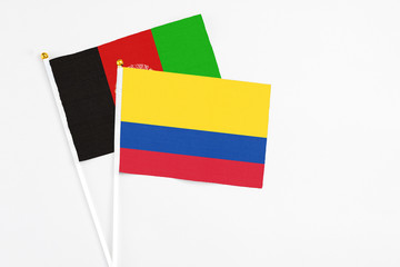 Colombia and Afghanistan stick flags on white background. High quality fabric, miniature national...
