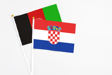 Croatia and Afghanistan stick flags on white background. High quality fabric, miniature national...