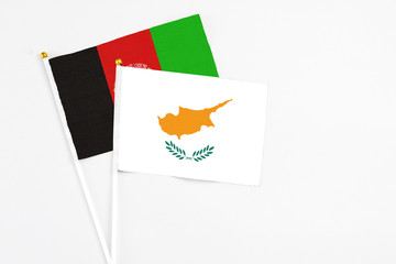 Cyprus and Afghanistan stick flags on white background. High quality fabric, miniature national...