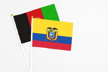 Ecuador and Afghanistan stick flags on white background. High quality fabric, miniature national flag. Peaceful global concept.White floor for copy space.