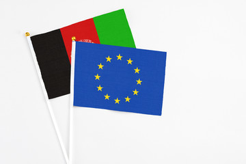 European Union and Afghanistan stick flags on white background. High quality fabric, miniature...