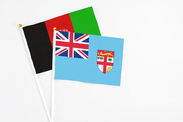Fiji and Afghanistan stick flags on white background. High quality fabric, miniature national flag....