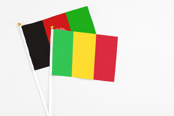 Mali and Afghanistan stick flags on white background. High quality fabric, miniature national flag....