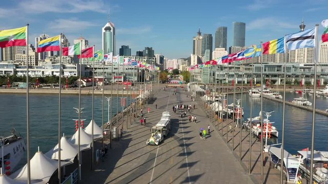 Drone flight through national flags of numerous countries at former Olympic sailing venue in Qingdao, China