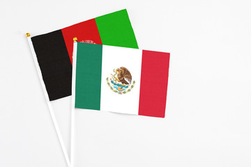 Mexico and Afghanistan stick flags on white background. High quality fabric, miniature national flag. Peaceful global concept.White floor for copy space.