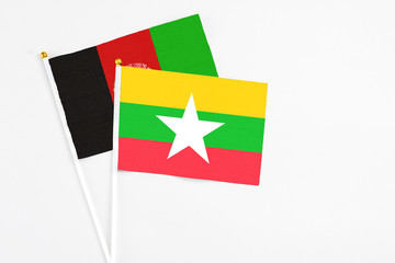 Myanmar and Afghanistan stick flags on white background. High quality fabric, miniature national flag. Peaceful global concept.White floor for copy space.