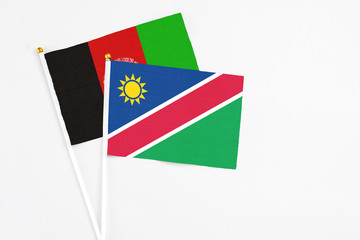 Namibia and Afghanistan stick flags on white background. High quality fabric, miniature national...