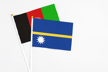 Nauru and Afghanistan stick flags on white background. High quality fabric, miniature national...