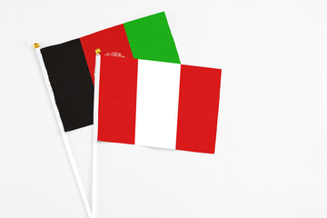 Peru and Afghanistan stick flags on white background. High quality fabric, miniature national flag....