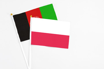 Poland and Afghanistan stick flags on white background. High quality fabric, miniature national...