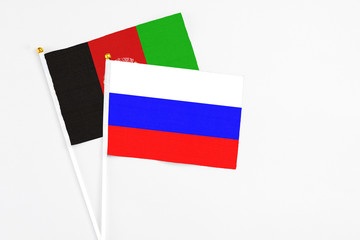 Russia and Afghanistan stick flags on white background. High quality fabric, miniature national...