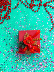 Red gift box in trendy mint green colors tones. Flat lay background. Festive concept.
