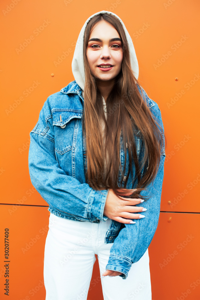 Wall mural young pretty teenage girl posing cheerful happy smiling wearing street style outside in europe city,