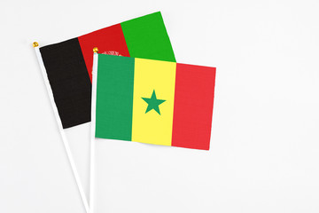 Senegal and Afghanistan stick flags on white background. High quality fabric, miniature national...
