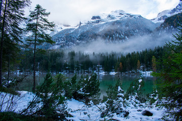 In winter comes the fog on the lake of tovel in Trentino Italy
