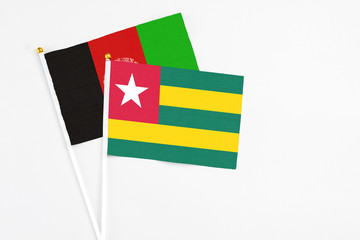 Togo and Afghanistan stick flags on white background. High quality fabric, miniature national flag....