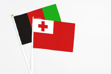 Tonga and Afghanistan stick flags on white background. High quality fabric, miniature national...