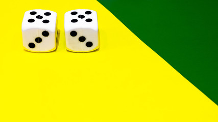 dice on yellow and green background 